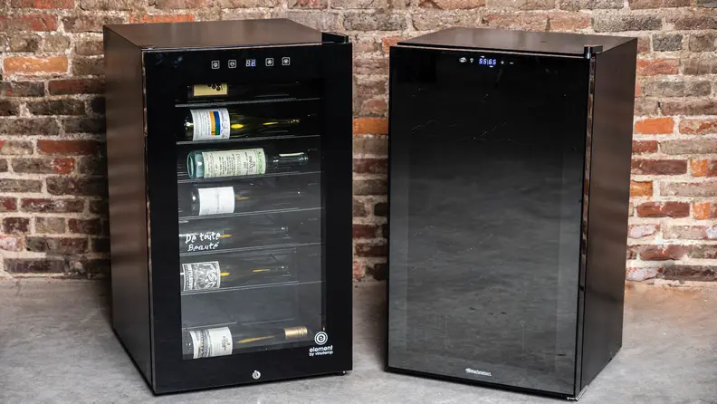 The Vinotemp 42-bottle and WineEnthusiast 32-bottle fridges side-by-side against a brick wall.