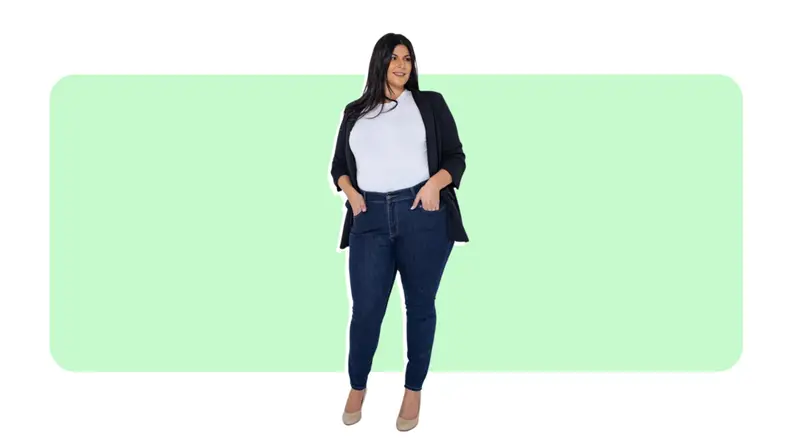 A model wears blue skinny jeans with a white T-Shirt and black cardigan.