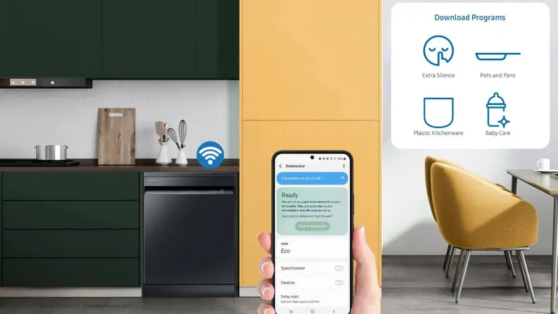 A person holding up a smartphone displaying an app in a kitchen.