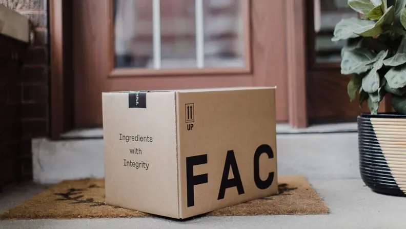 Factor box sitting outside, in front of a house