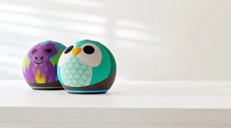 Two new Amazon Echo Dot for Kids smart speakers sit on a white table