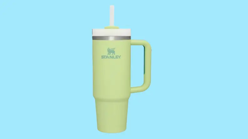 Green Stanley cup against blue background