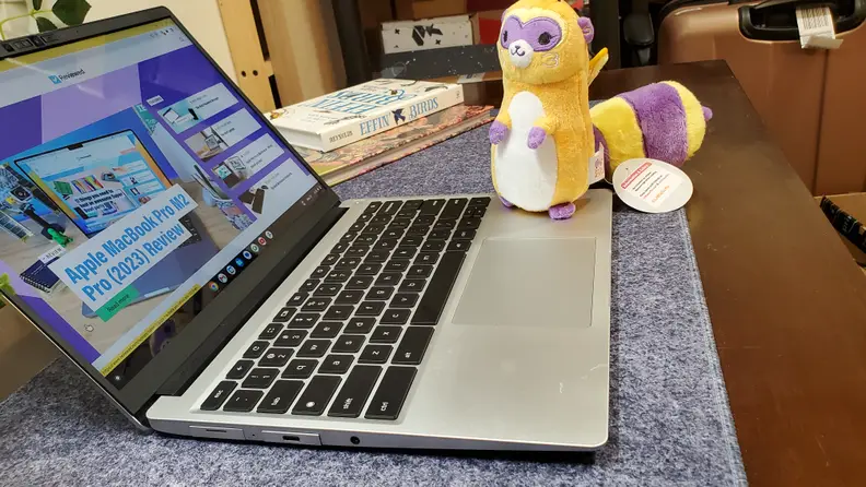The Framework Chrome on a desktop with a stuffed animal next to it.