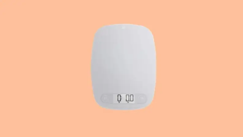Product image of the Greater Goods digital kitchen scale on a Reviewed background.
