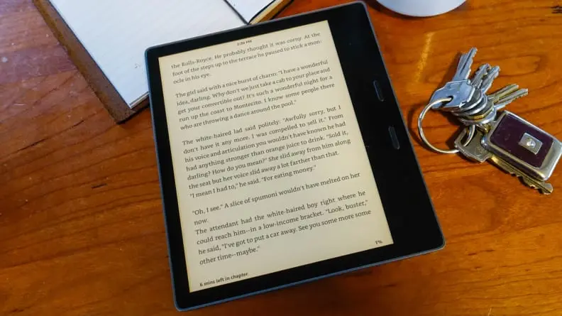 The Kindle Oasis, rested on a table, showing text from a book.