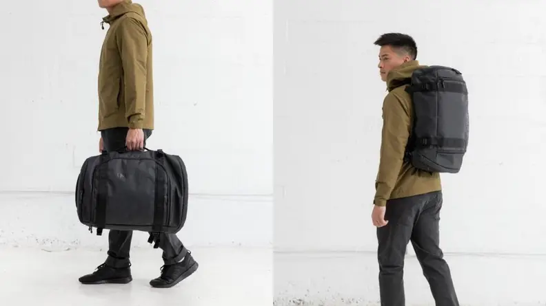 man holding Timbuk2 travel bag, man wearing Timbuk2 backpack