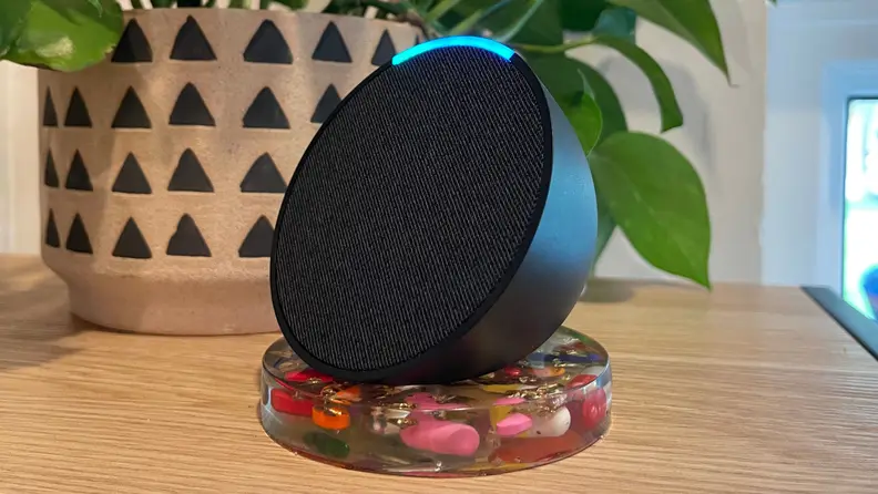 The Amazon Echo Pop sitting on a coaster.