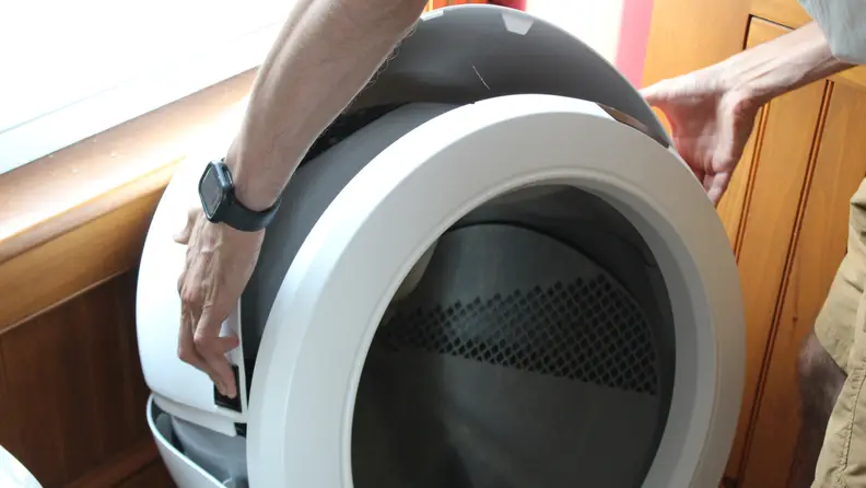 A person lifting the bonnet off the Litter-Robot 4
