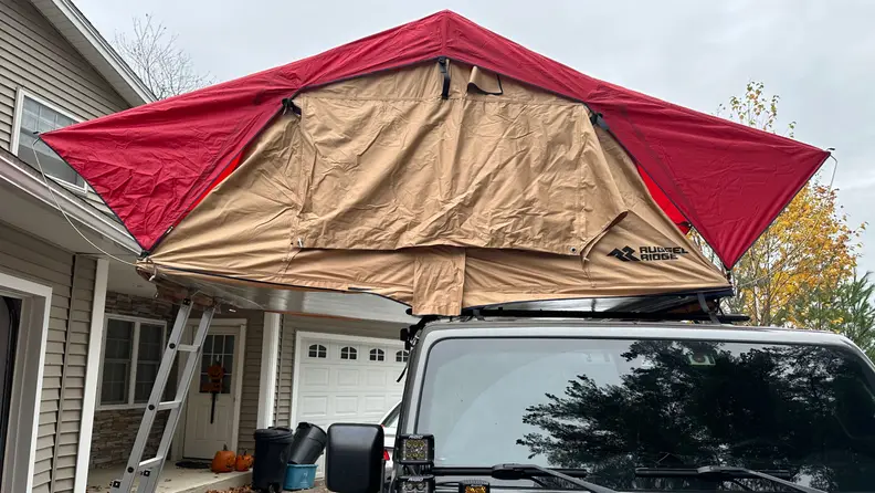 Front view of the Rugged Ridge Roof Top Tent over a gray Jeep Wrangler Rubicon.