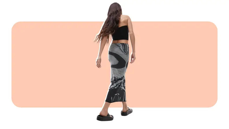 A model wearing a black and gray marble-print midi skirt.
