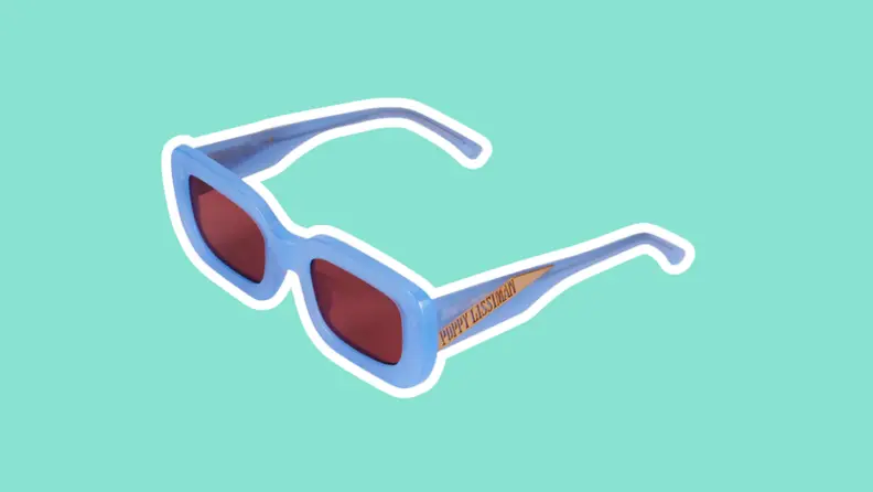 The Poppy Lissiman Chesko Sunglasses on a green background.