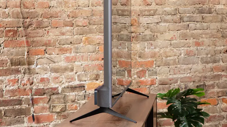 Angled shot of the Roku Plus Series QLED TV on a TV stand.