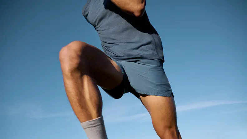 man wearing allbirds natural run shorts.
