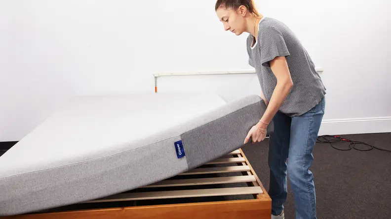 A person lifting the edge of The Casper mattress.