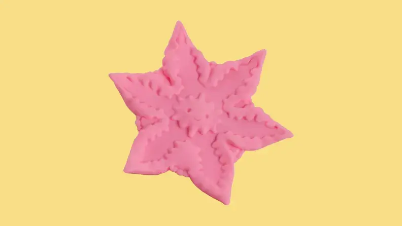 A pink Starsi starfish-shaped vibrator on a yellow background