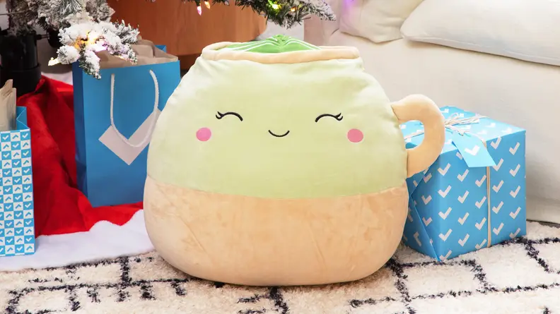 A Squishmallow next to Reviewed gift boxes.