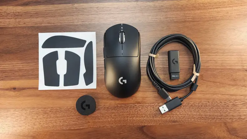 The Logitech G Pro X Superlight 2 with a USB dongle, cable, mouse padding and a cover.