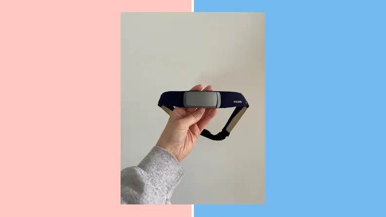 A hand holding the Muse S headband.
