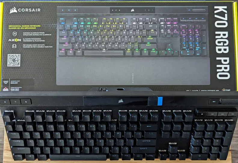 A keyboard standing up aganist its box