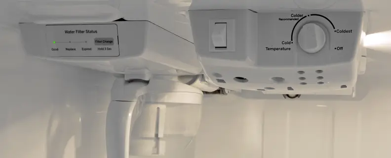 The GE GAS18P fridge uses a vague dial thermostat. Turn it down a bit below the recommended mark for optimal temperatures.