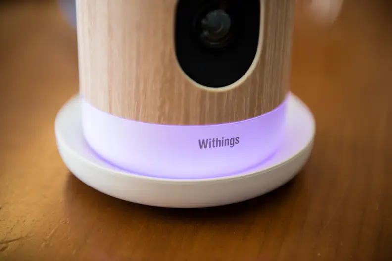 The base of the Withings Home glowing purple.