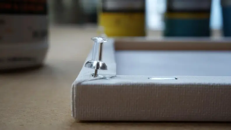 Thumbtack in the back of a canvas