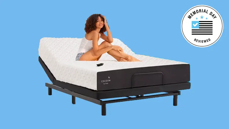 A woman sitting on a partially reclined Cocoon mattress against a blue background.