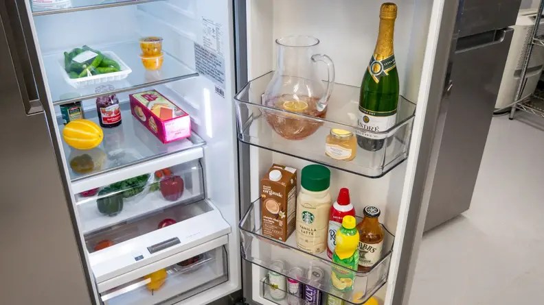 Close-up shot of interior door storage on the Midea MRS26D5AST Side-by-Side Refrigerator.
