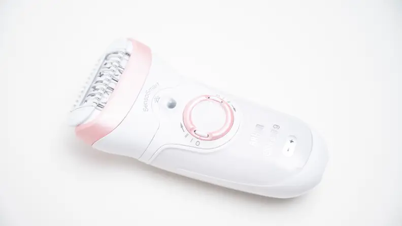 The Braun Silk-Epil 9 laying on a white background.