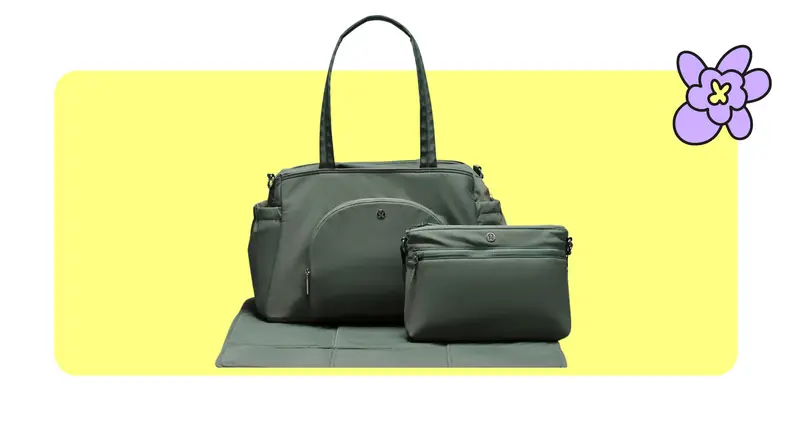 Product shot of the lululemon baby tote bag with smaller toiletry bag in front of it in Grey Eucalyptus/Trench color in front of a yellow background with a purple cartoon flower in the corner..