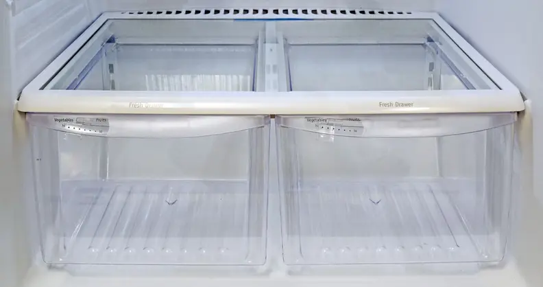 Two empty crisper drawers side by side on the bottom level of a fridge,