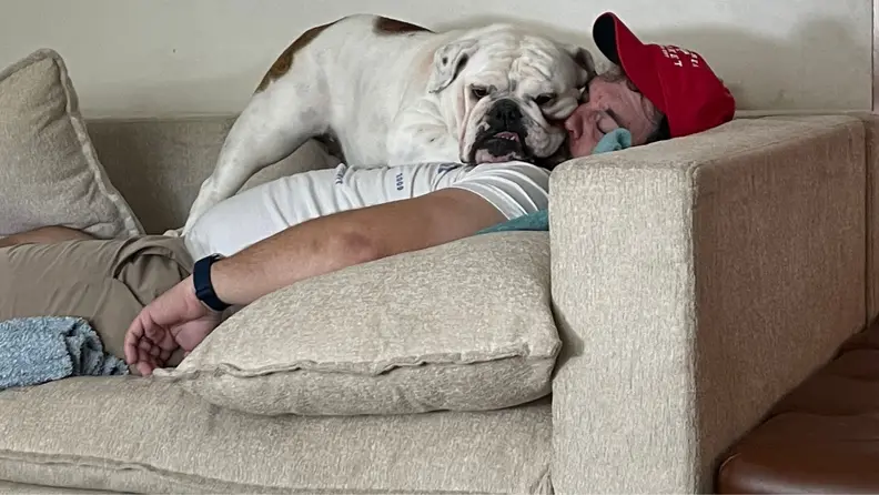 A man and dog sitting on the Kova Sofa