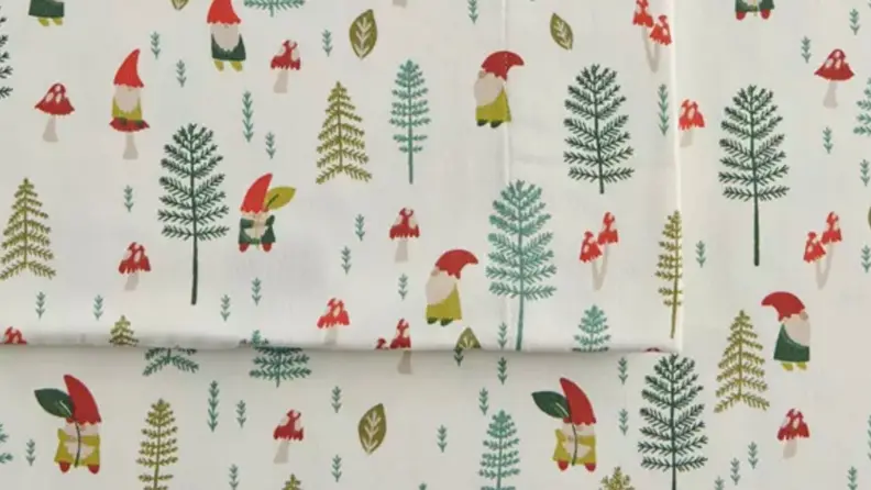 a set of flannel sheets from cuddl duds featuring gnomes and trees