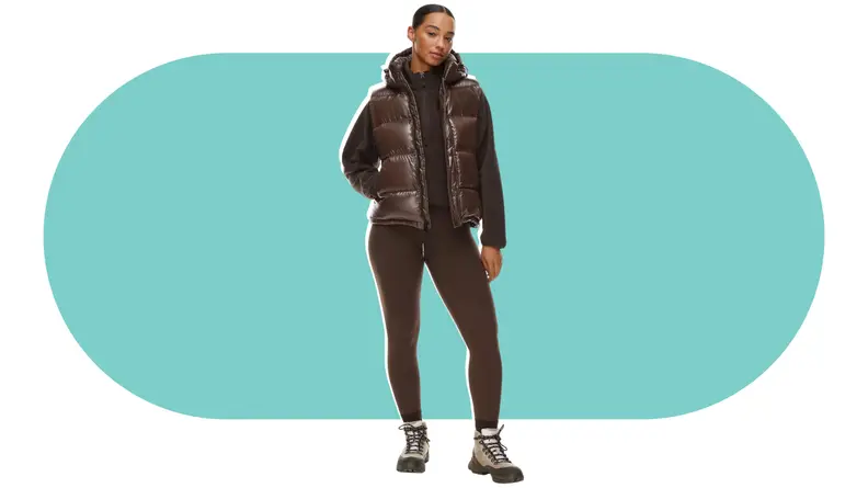 A model wearing a brown puffer vest.