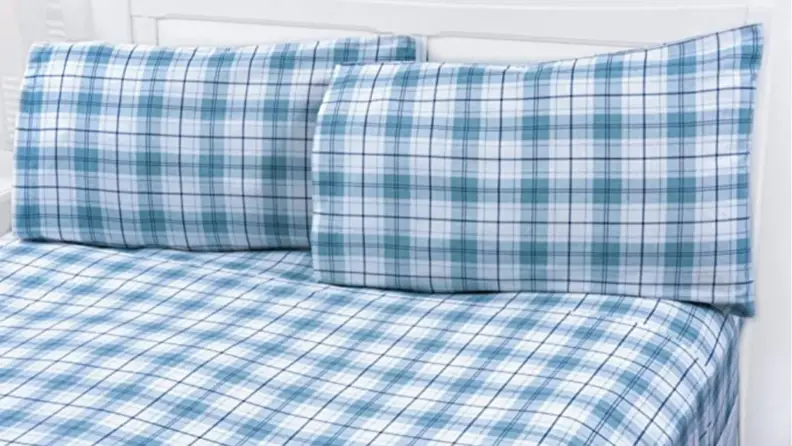 the mellani flannel sheets in blue plaid on a bed