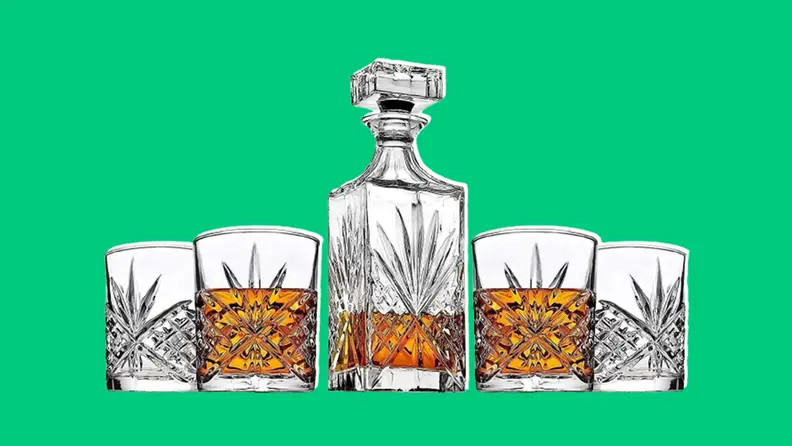 Whiskey decanter set on dark green background