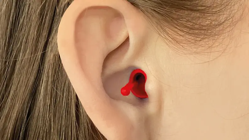 Person wearing red earbud in ear canal to block out sound.