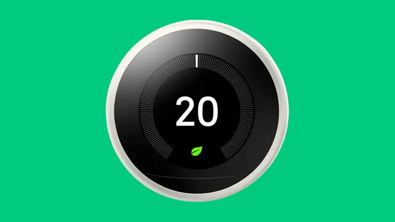 Black google nest thermostat on green background
