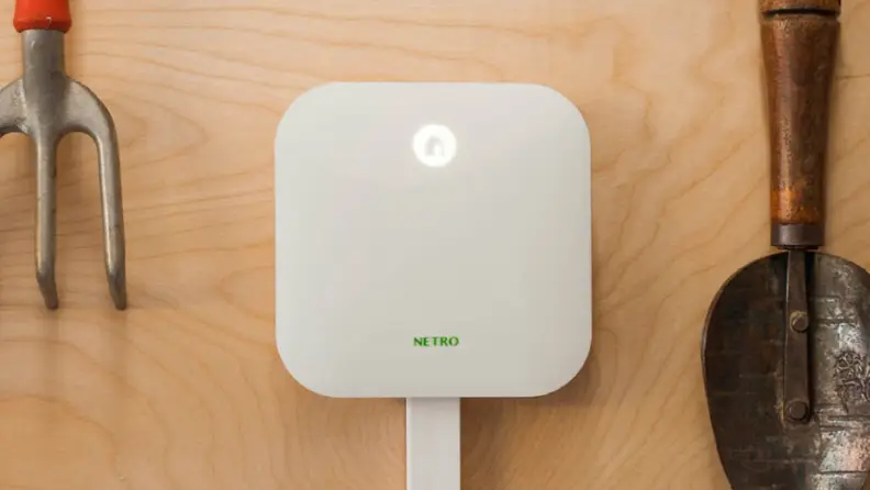 Netro Sprite Smart Sprinkler Controller mounted on plywood with tools