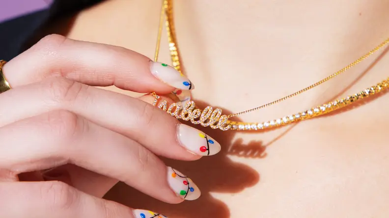 hand holding gold necklace