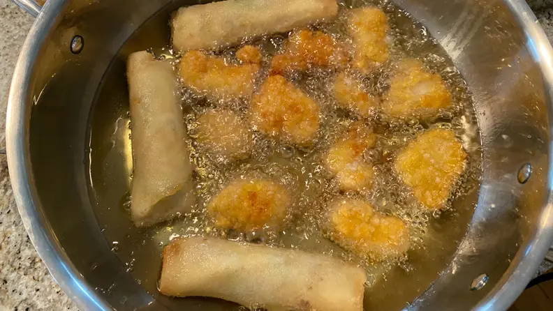The Hestan Cue 5.5-Quart Chef's Pot is frying up some chicken tenders and egg rolls.