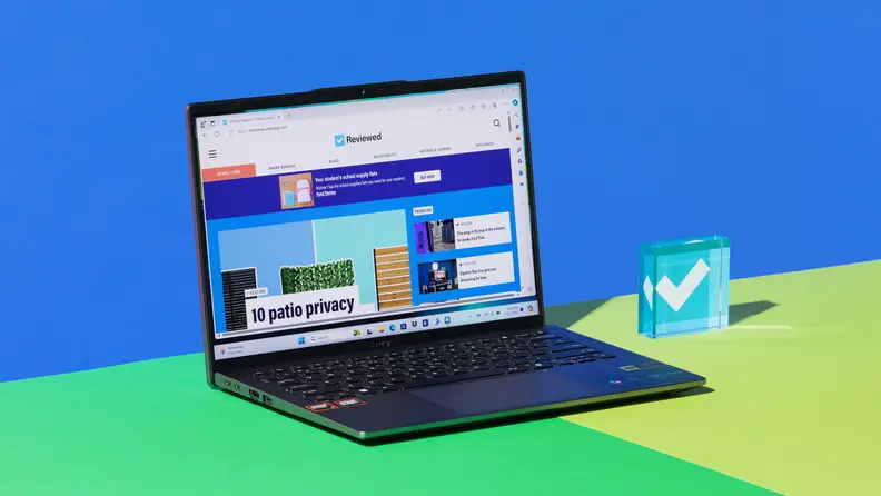 The 2024 version of the Acer Swift Go 14 laptop sitting on top on green contrast surface.