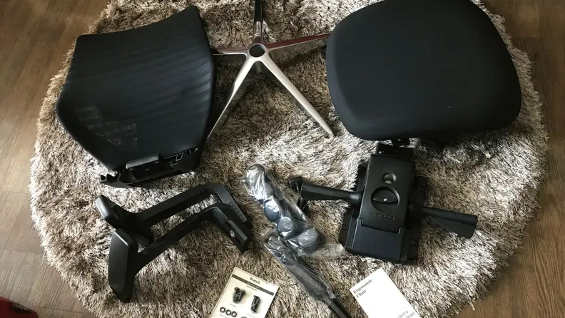 The Branch Ergonomic Chair disassembled on the floor