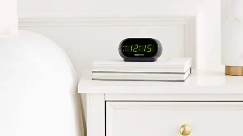 the amazonbasics alarm on a bedside table