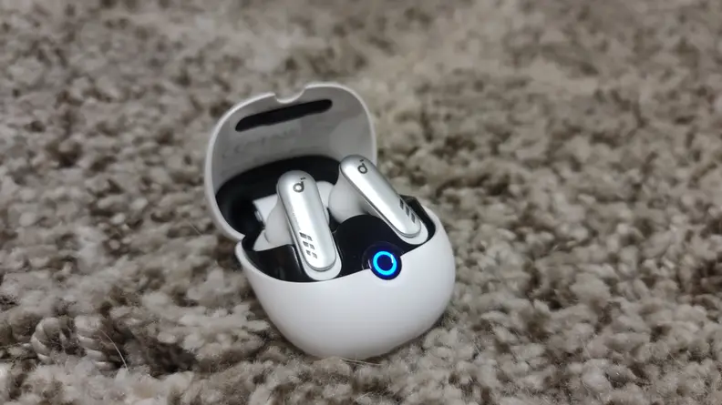 A white earbud case on a carpet