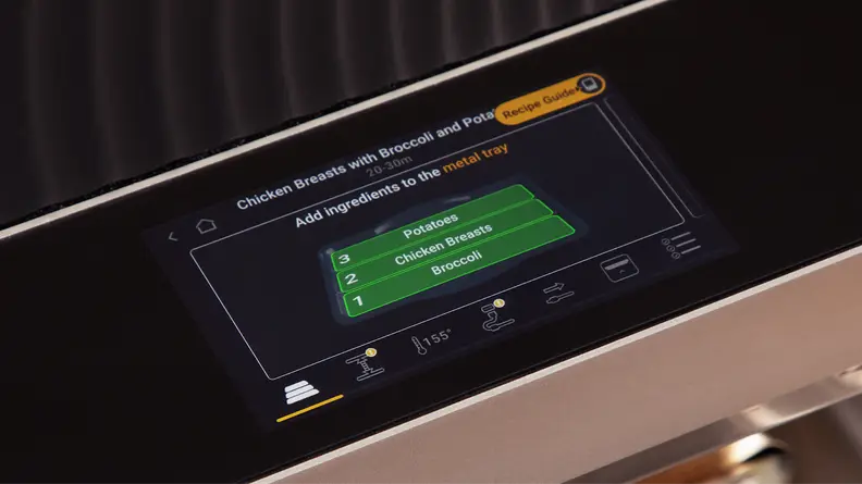 A closer view of the Brava Glass oven's touchscreen featuring different cooking zones for chicken breasts, broccoli and potatoes.