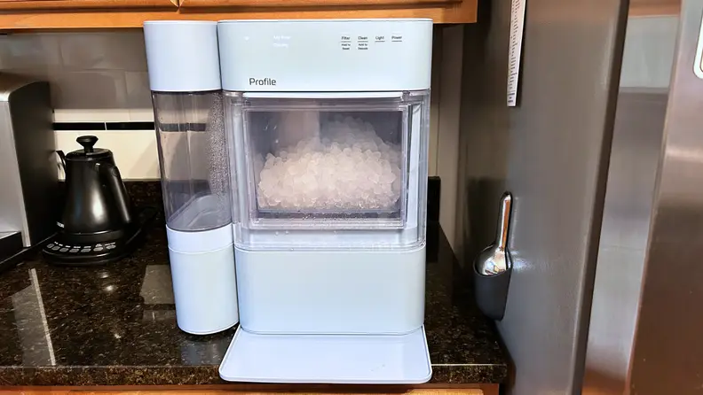 The ice maker sits on a kitchen countertop