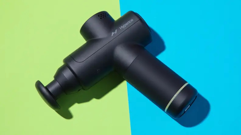 The Hyperice Hypervolt 2 Go on a green and blue background.