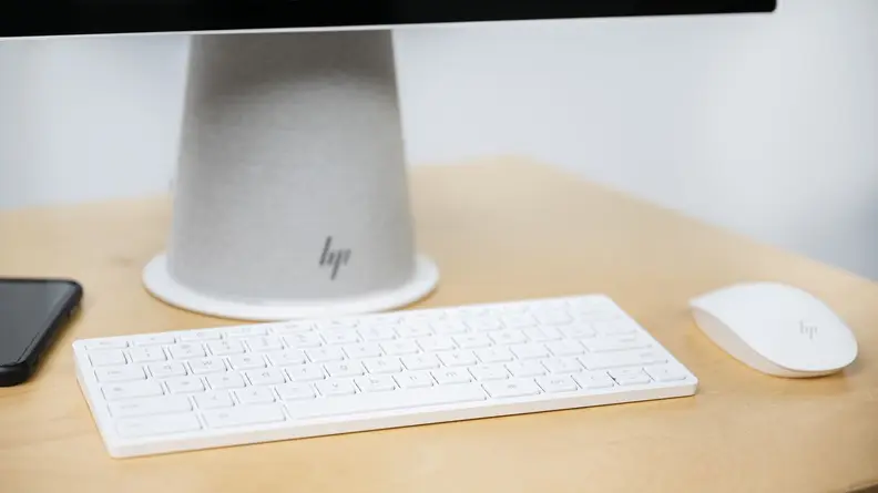 A closeup of the computer base with the keyboard and mouse in front