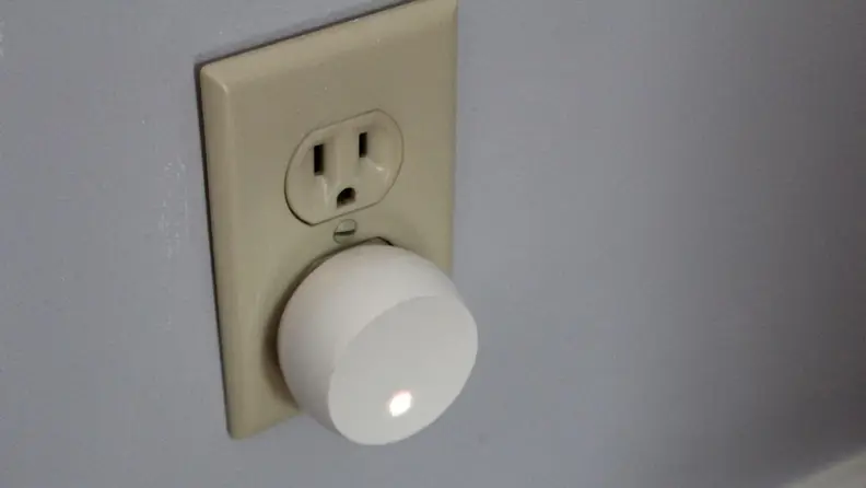 The Level Connect hub plugged into an electrical outlet.
